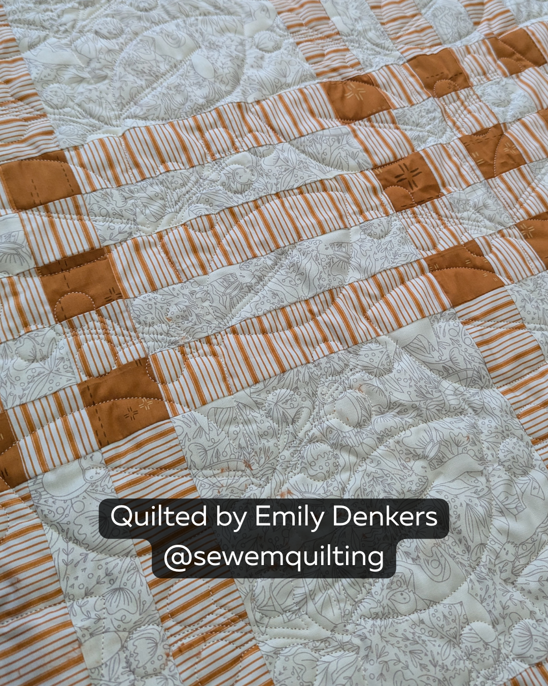 Finished cream and rust patchwork quilt featuring the Berry Branches quilting pantograph, with flowing botanical branches, leaves, and berry clusters stitched edge to edge.