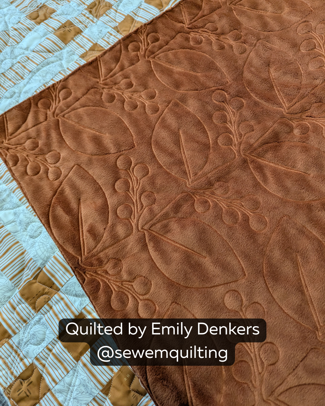 Close-up of a rust brown quilt featuring the Berry Branches quilting pantograph, with flowing branches, large leaves, and berry clusters stitched edge to edge.