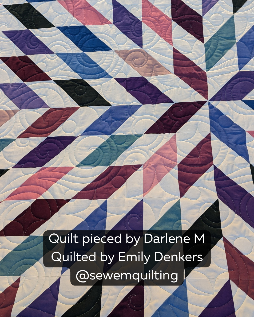 Charming Twinkles longarm quilting design adds whimsical swirls and elegant texture to this contemporary multicolor quilt with striking pieced blocks