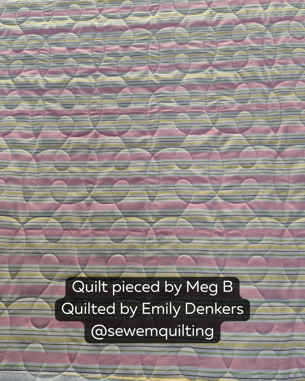 Delicate Continuous Loop pantograph stitched across a soft pastel quilt with flowing loop motifs and elegant edge-to-edge quilting texture.