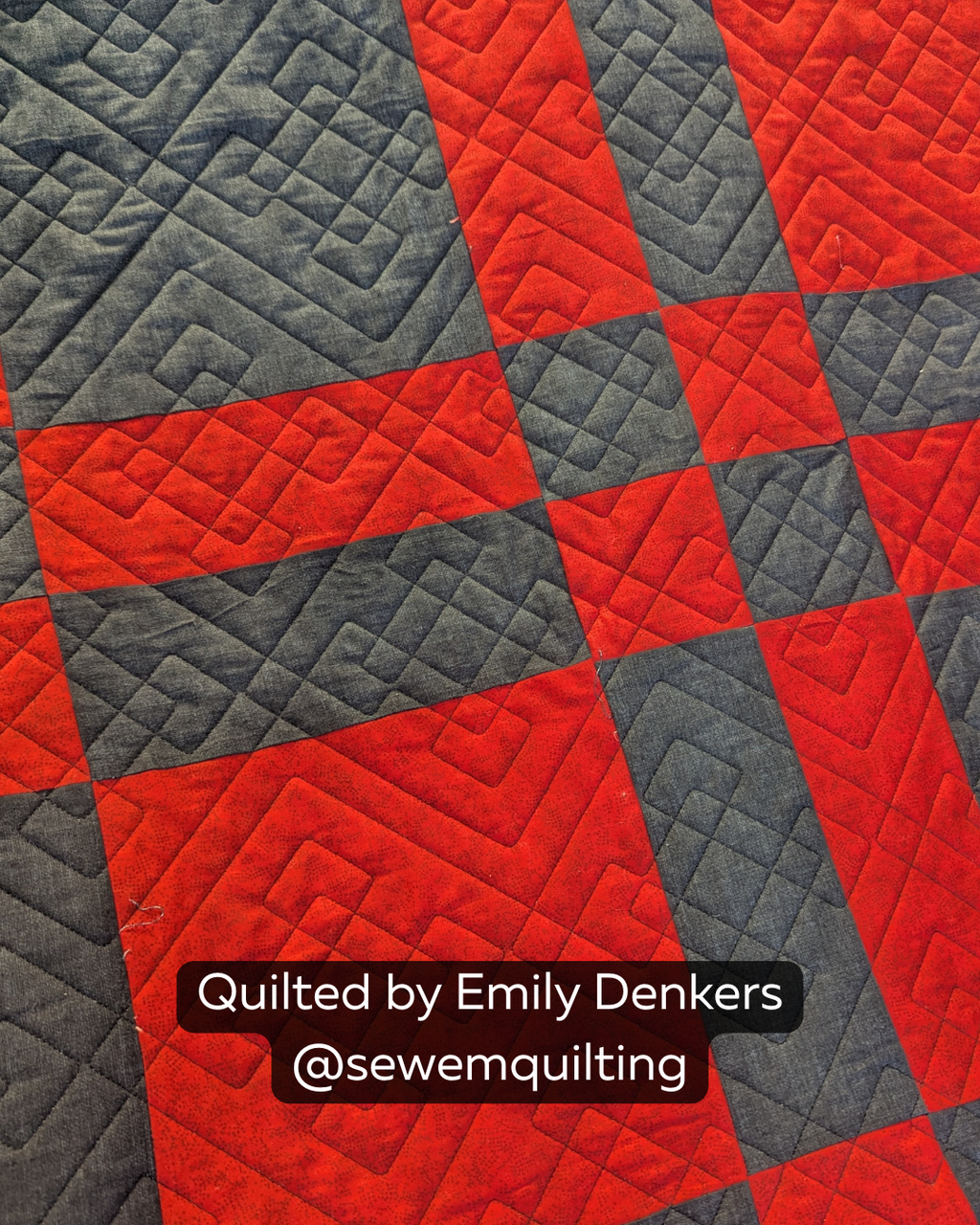 Finished red and charcoal quilt featuring the Double Plaid quilting pantograph, with bold layered geometric lines creating a modern woven plaid effect.