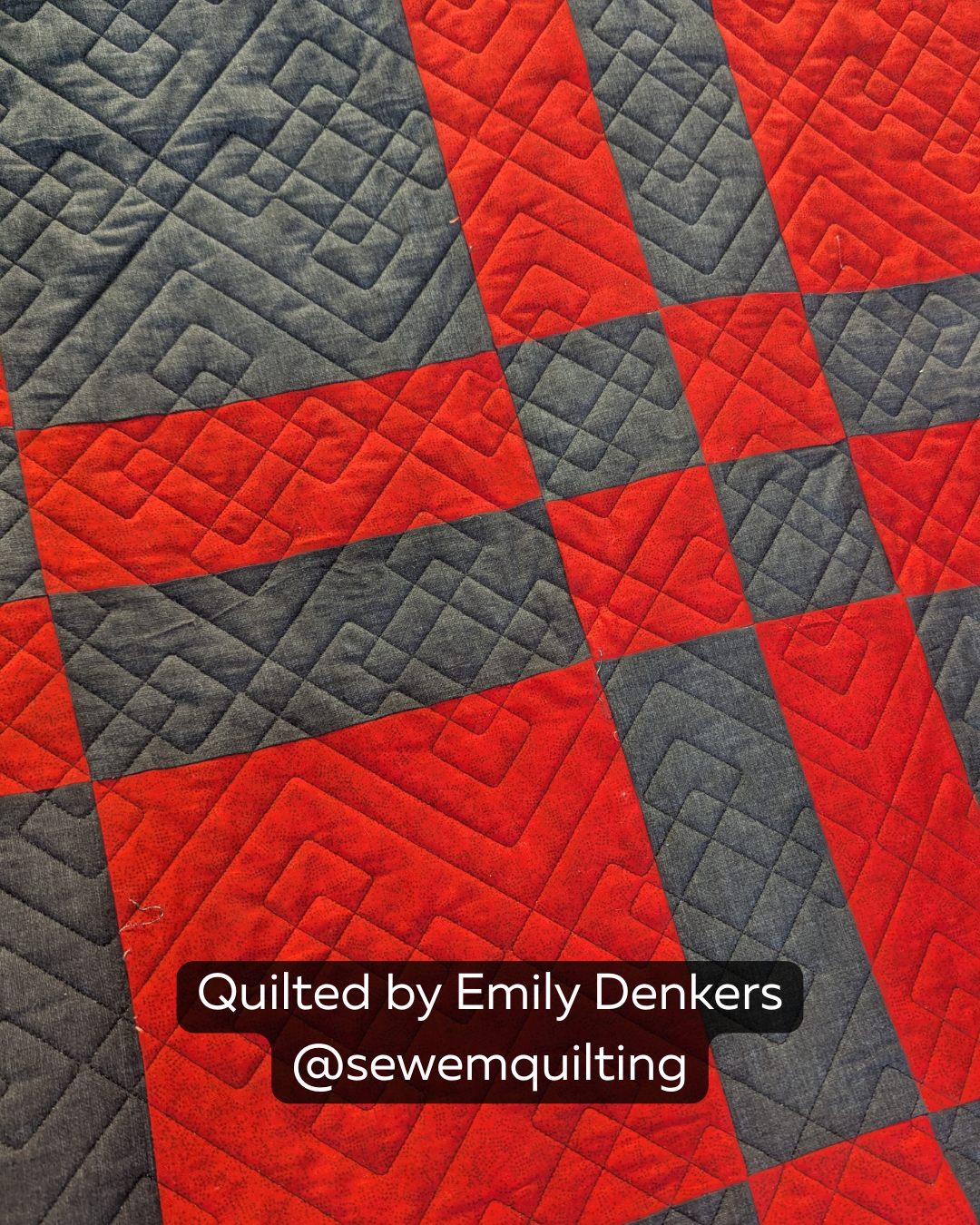 Finished red and charcoal quilt featuring the Double Plaid quilting pantograph, with bold layered geometric lines creating a modern woven plaid effect.