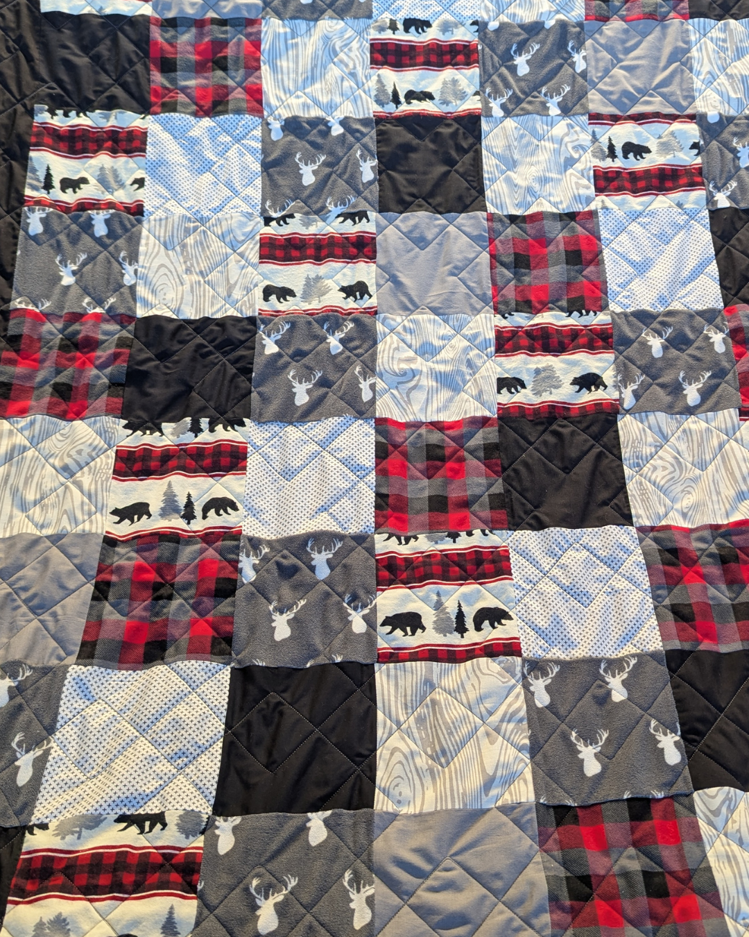 Exes Simple Square geometric pantograph stitched on a modern quilt, featuring clean X-shaped lines and repeating square quilting motifs.