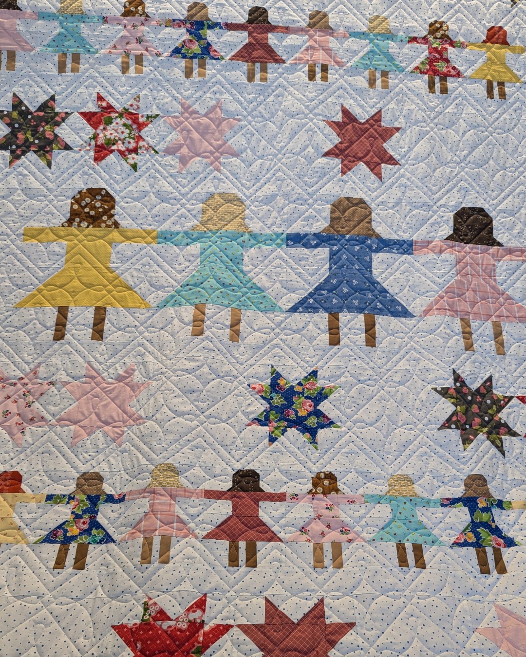 Eyelet Squares geometric loop pantograph stitched on a playful quilt, featuring repeating square shapes and flowing curves for a modern longarm quilting design.