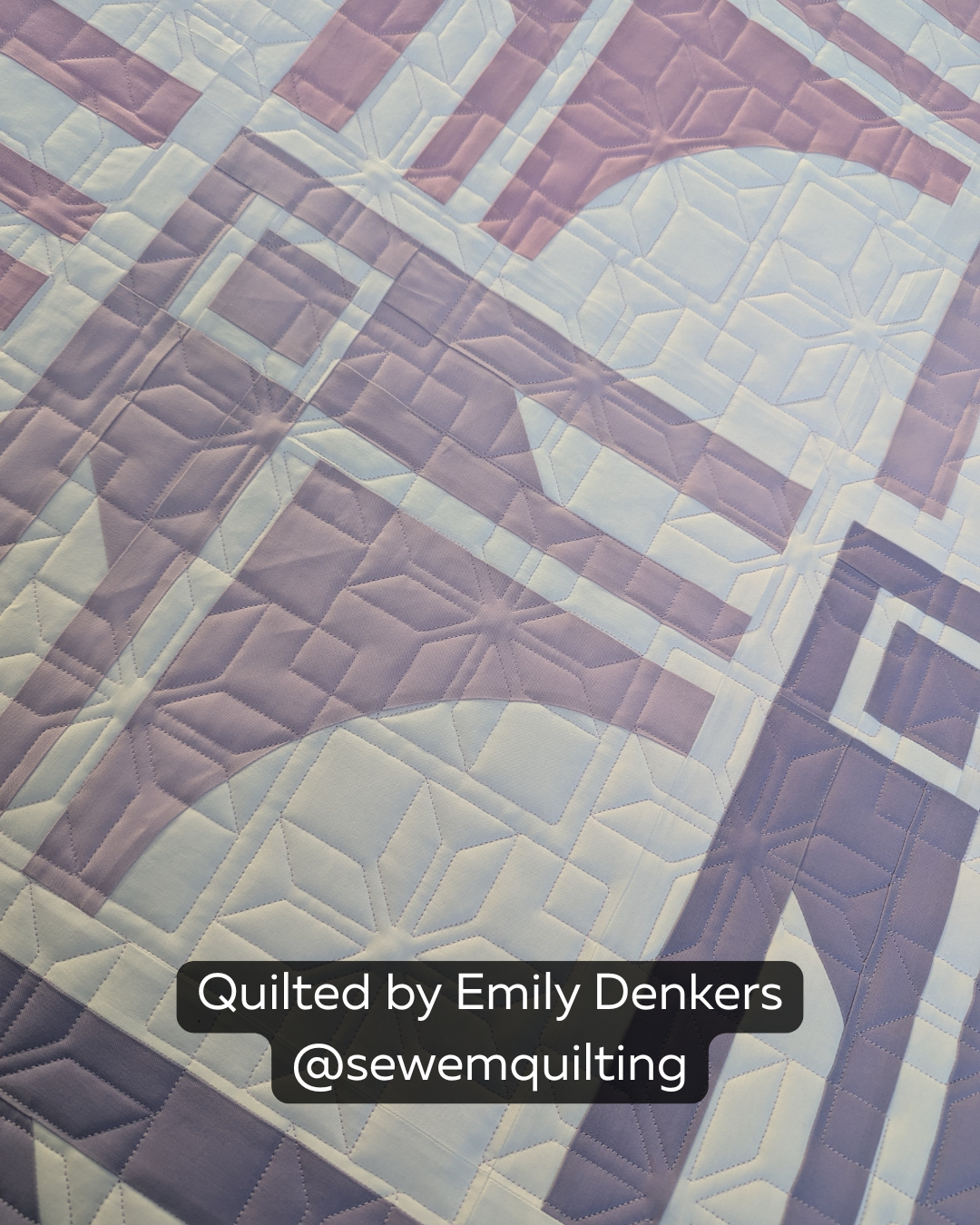 Finished lavender and white quilt featuring the Fair Isle Squares quilting pantograph, with crisp geometric snowflakes and square motifs stitched edge to edge.
