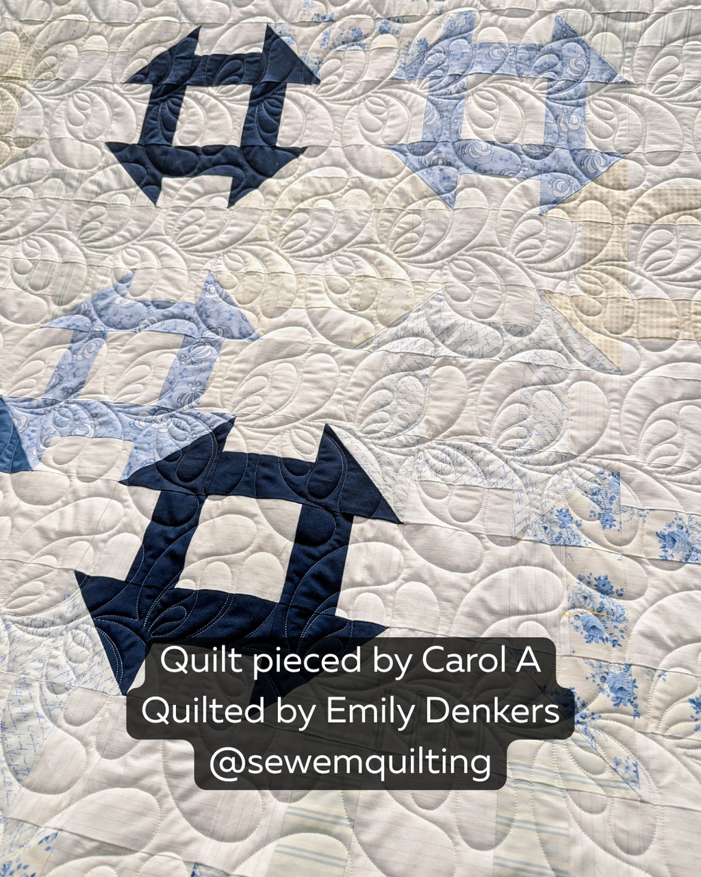 Feather Floof feather digital pantograph stitched on a blue and white quilt, featuring flowing feather motifs and elegant longarm quilting texture.