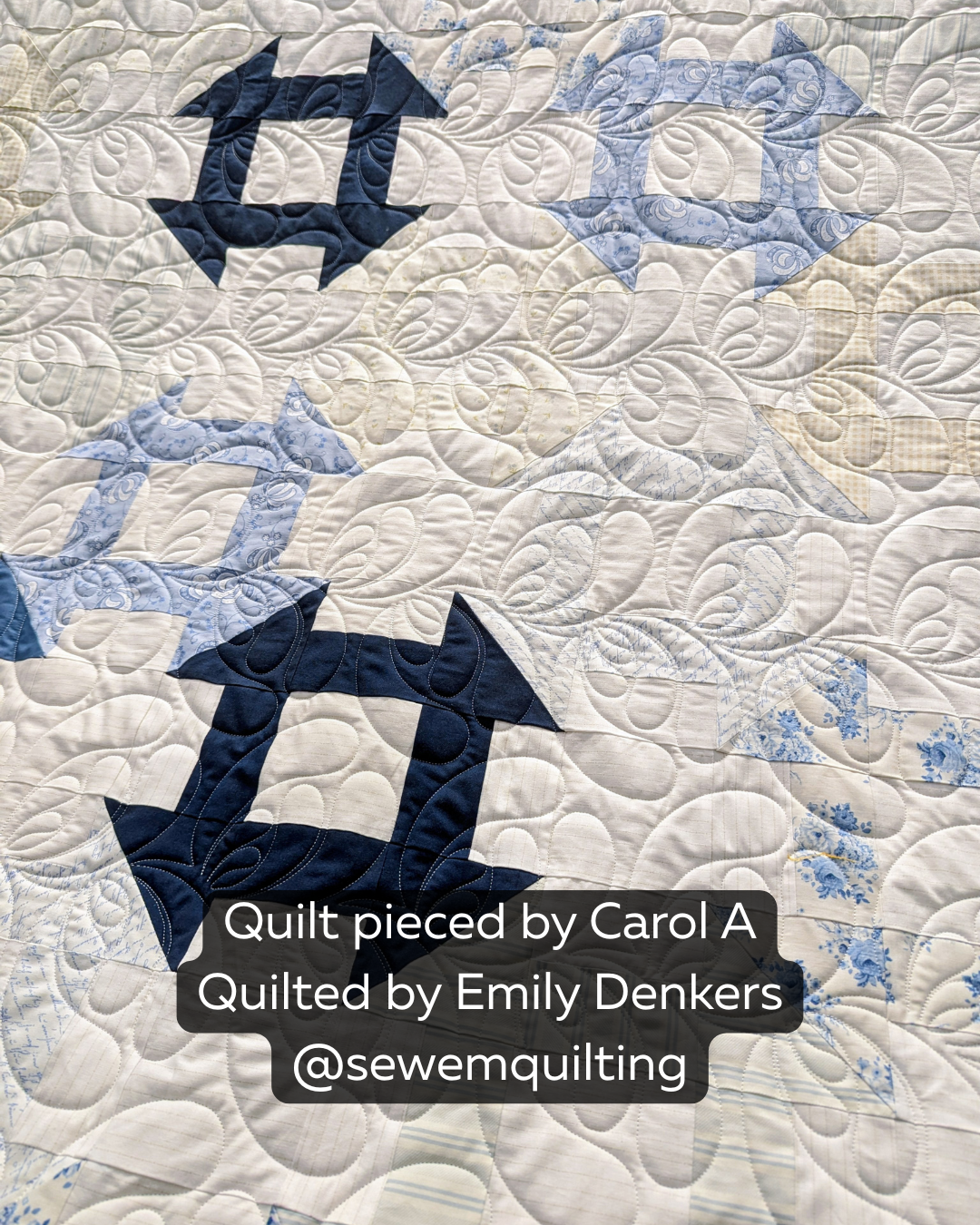 Feather Floof feather digital pantograph stitched on a blue and white quilt, featuring flowing feather motifs and elegant longarm quilting texture.