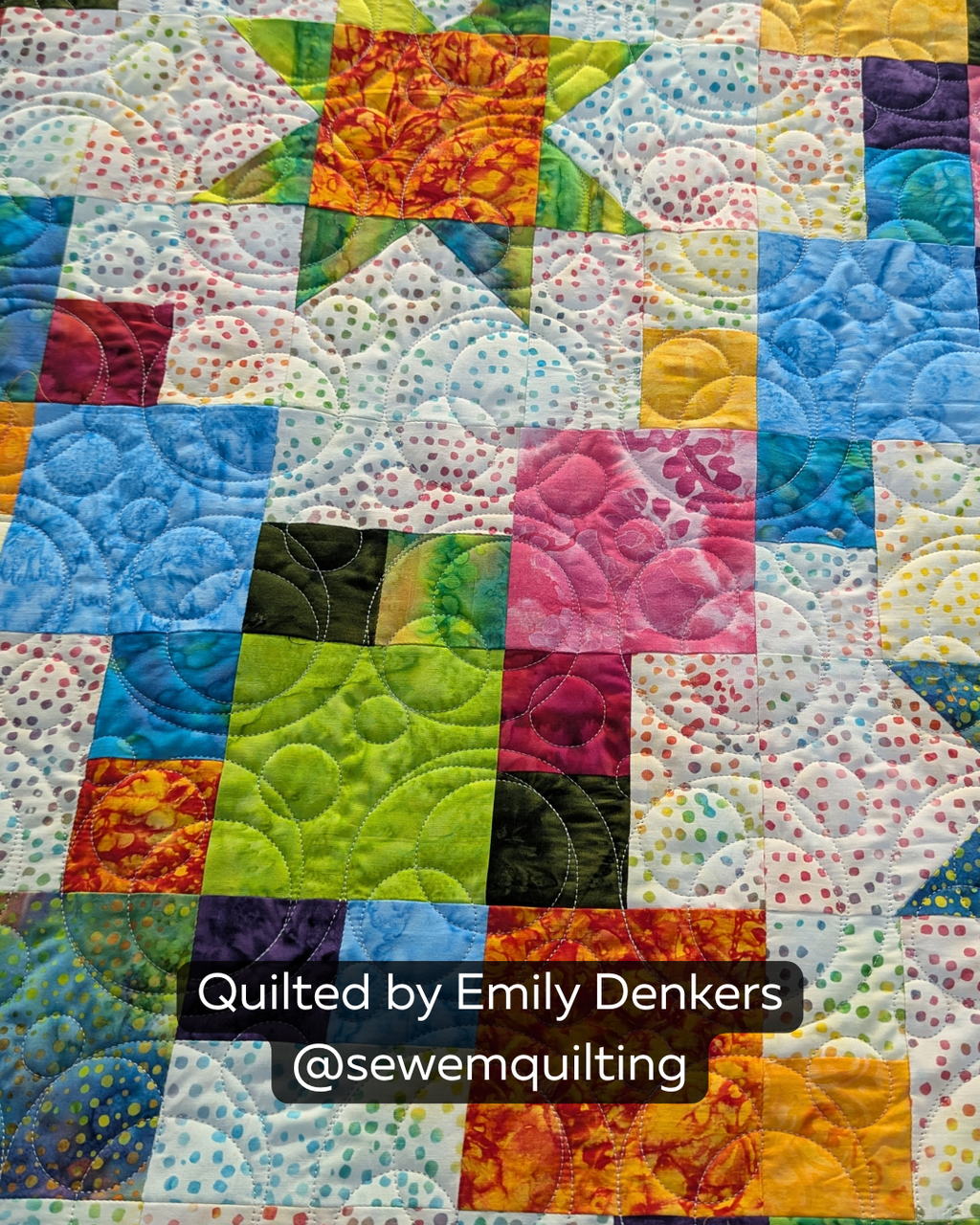 Finished colorful patchwork quilt featuring the Fizz bubble quilting pantograph, with playful loops and rounded bubble shapes stitched edge to edge.