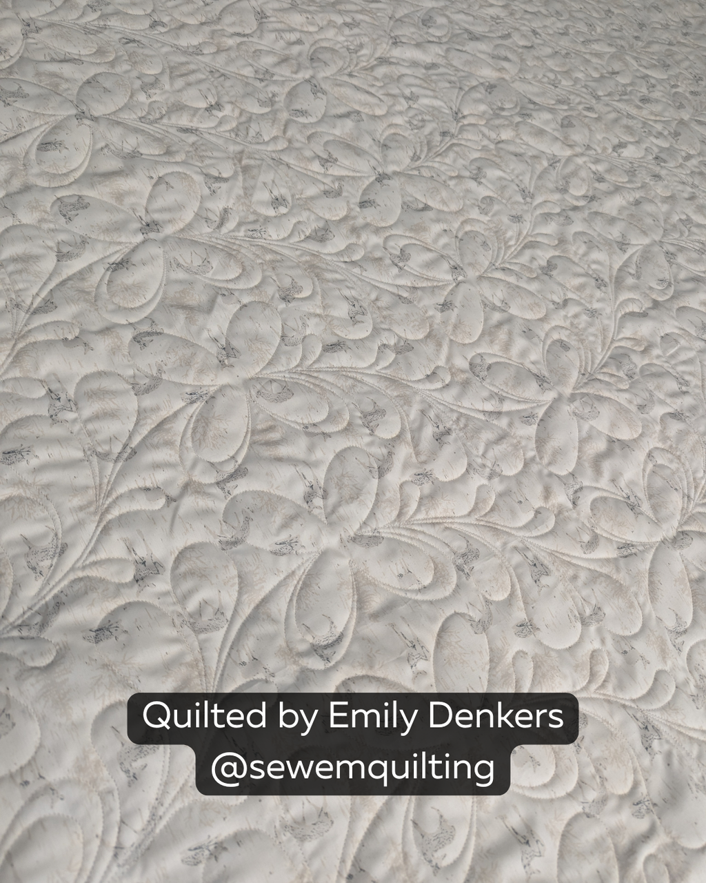 "Finished quilt example using the For Jane floral pantograph, showing loopy floral vine stitching on a cream quilt top, quilted by Emily Denkers @sewemquilting"