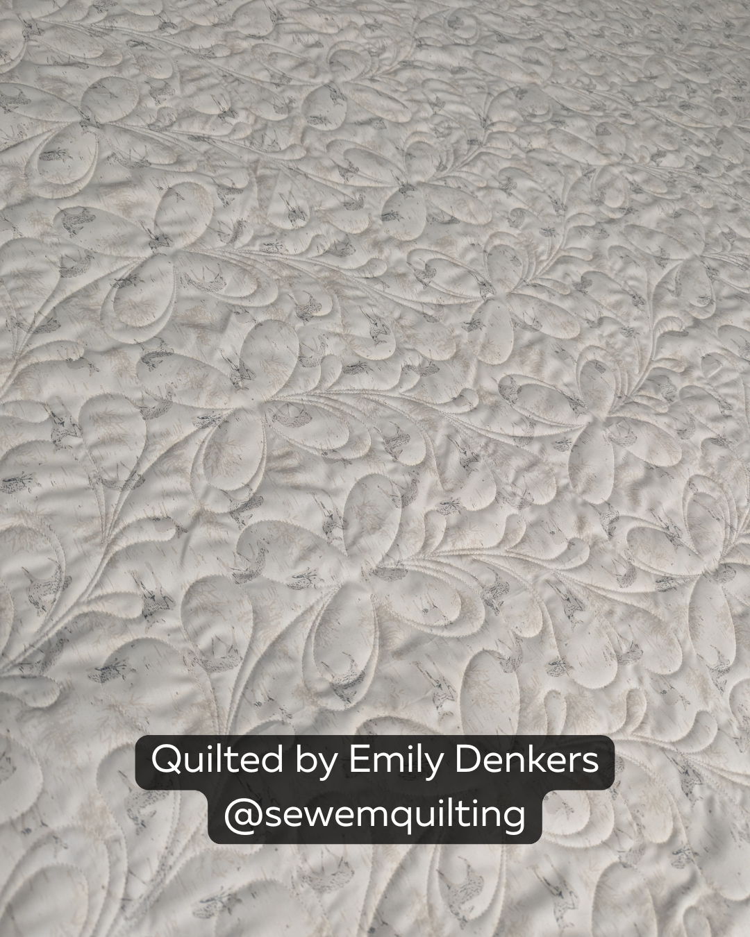 "Finished quilt example using the For Jane floral pantograph, showing loopy floral vine stitching on a cream quilt top, quilted by Emily Denkers @sewemquilting"