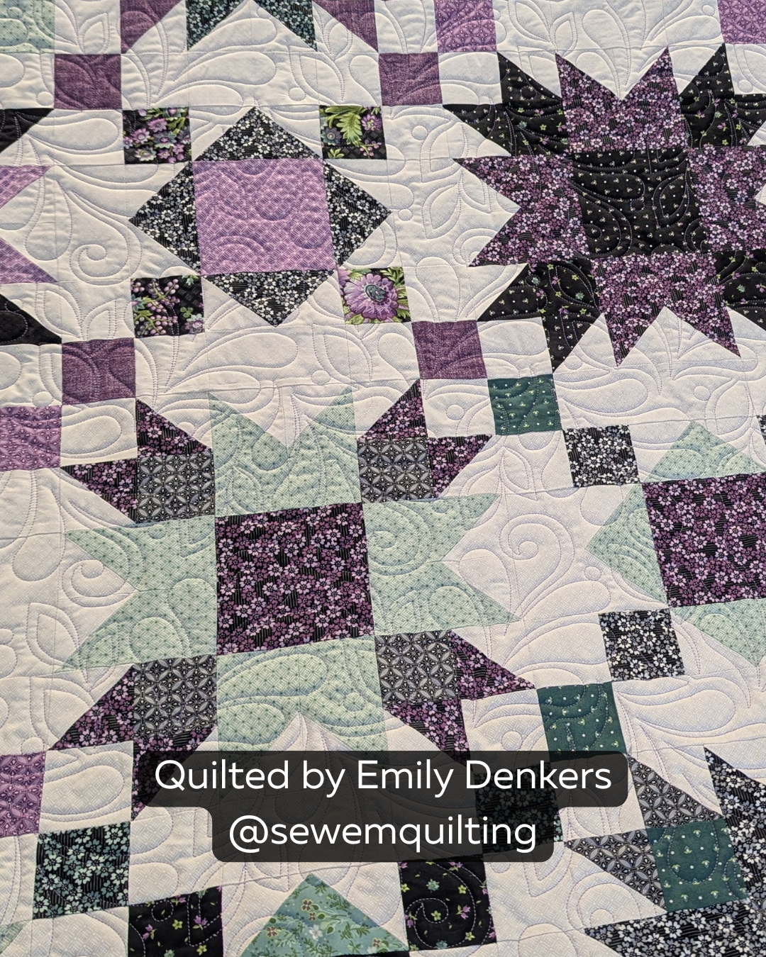 Finished purple, black, mint and white patchwork quilt featuring the Genesis quilting pantograph, with dramatic feather plumes and swirling leaves stitched edge to edge.