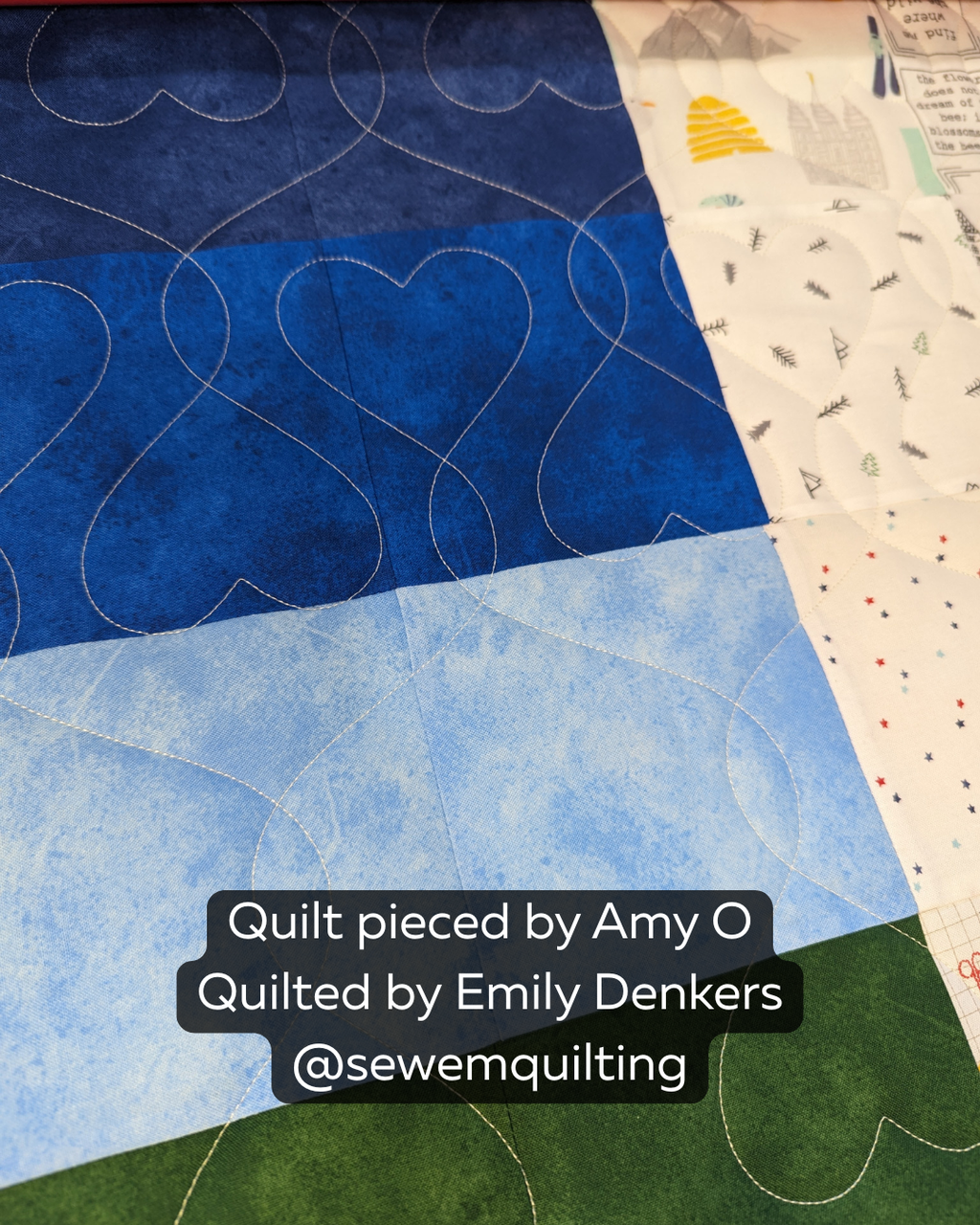 Heart Strings heart quilting pantograph stitched on a blue and white patchwork quilt, featuring flowing connected heart motifs for longarm quilting.