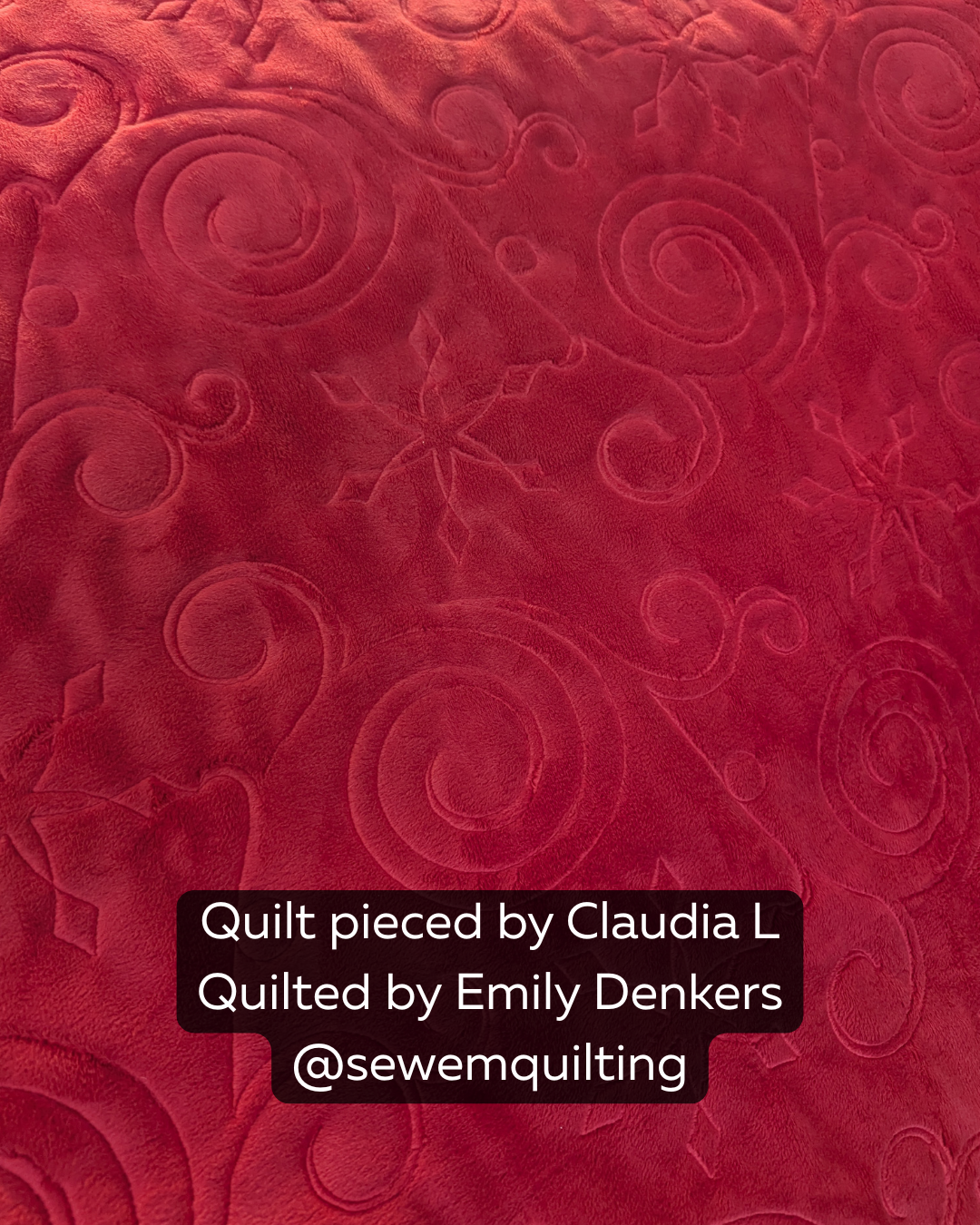 Ice Crystal Blitz Christmas pantograph stitched on a red quilt, featuring swirling snowflake-inspired curves and festive winter quilting texture.