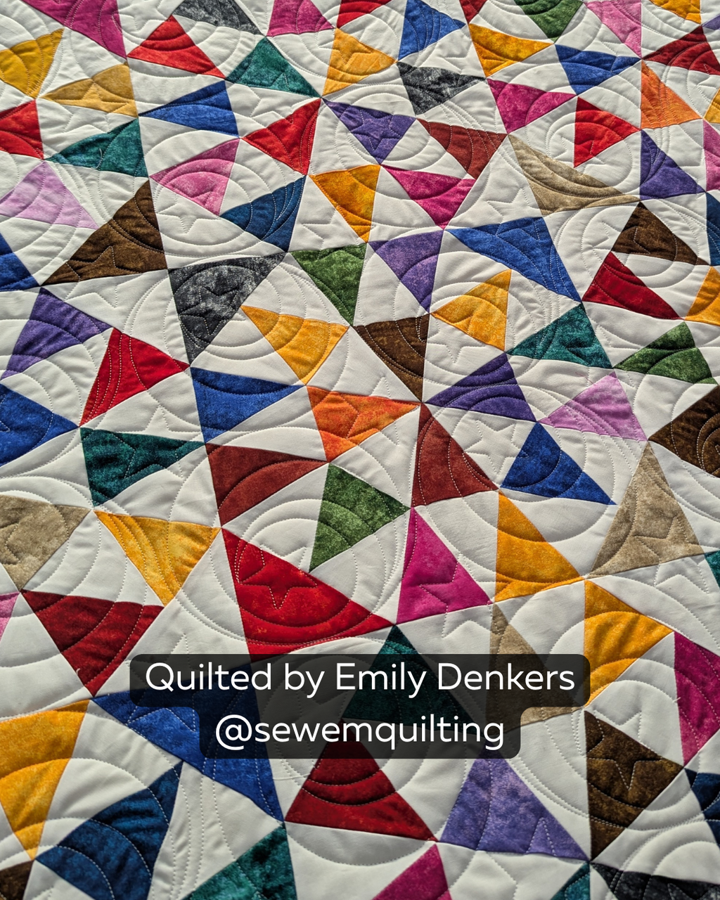 Finished colorful geometric quilt featuring the Marble Galaxy Stars quilting pantograph, with swirling stars adding cosmic edge-to-edge longarm quilting texture.