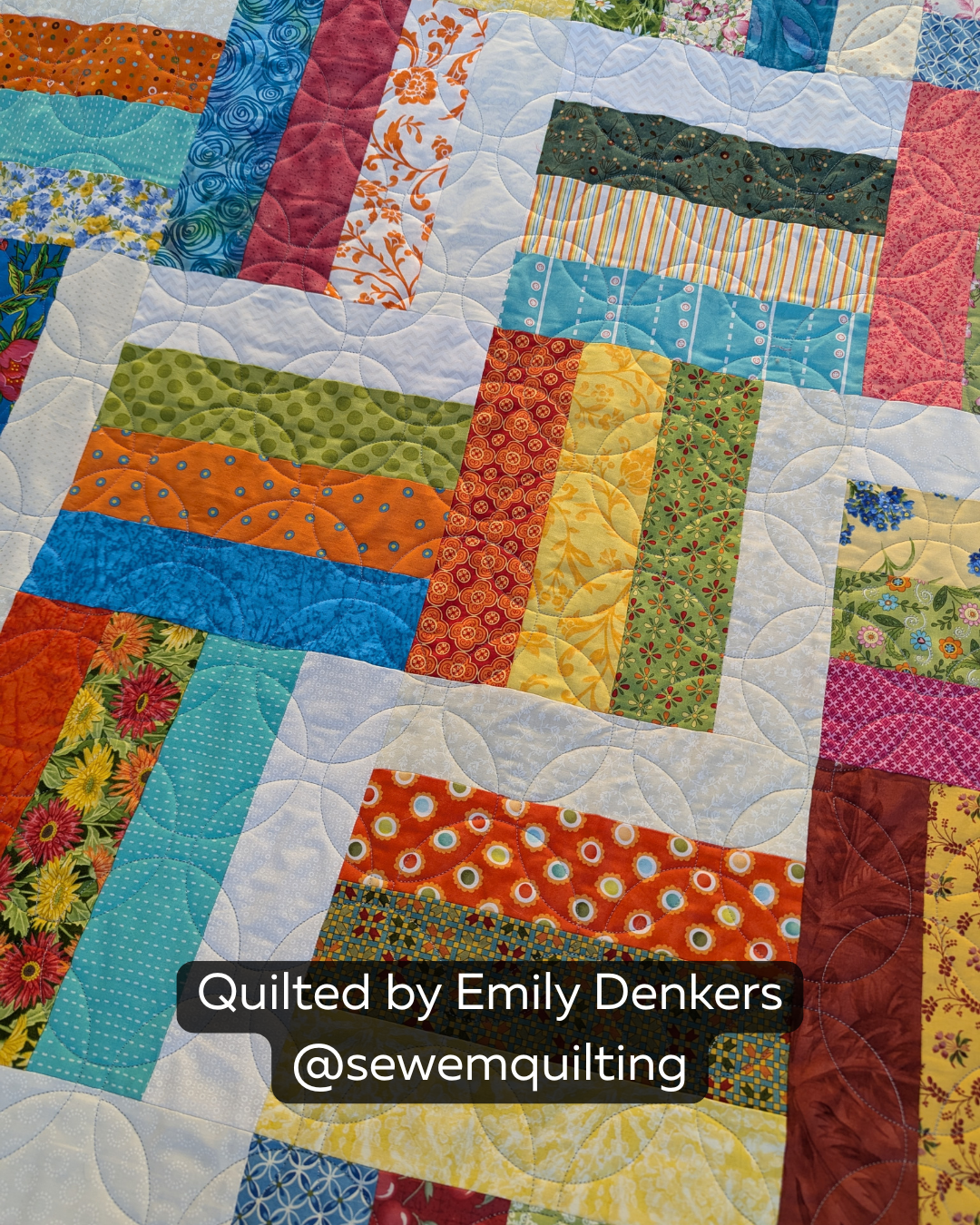 Finished colorful patchwork quilt featuring the Matchless Orange Peel Short digital quilting pantograph with elegant curved petals and flowing edge-to-edge texture