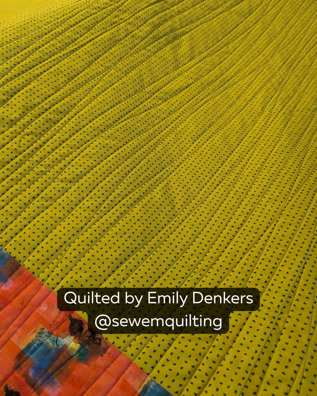 Finished quilt example using the Organic Extended Width minimalist pantograph, showing smooth wavy line stitching on a mustard yellow quilt back, quilted by Emily Denkers @sewemquilting