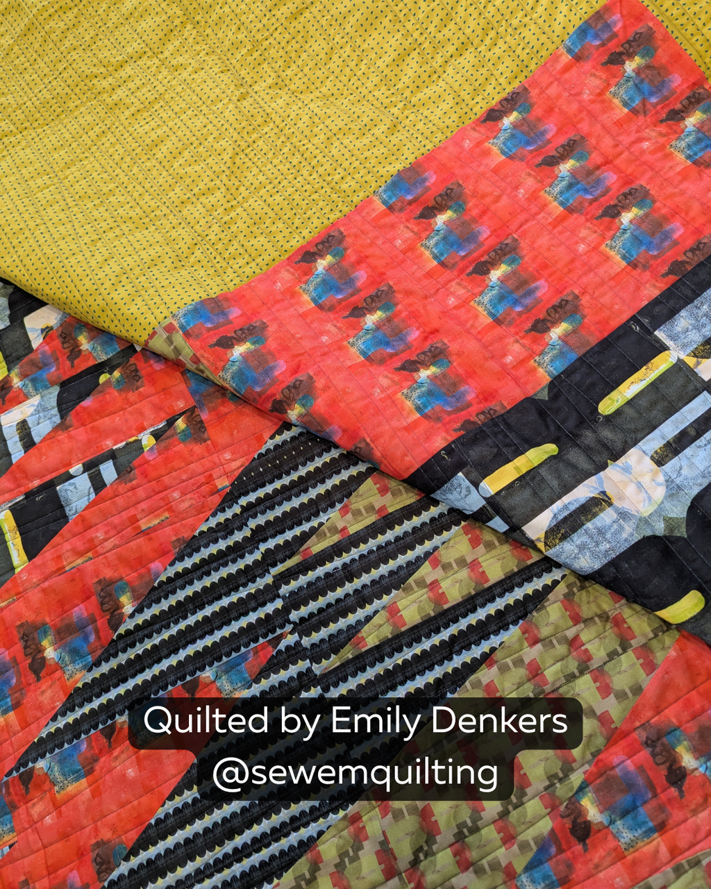 "Finished quilt example using the Organic Extended Width minimalist pantograph, showing smooth wavy line stitching on a bold red, black, and mustard modern quilt, quilted by Emily Denkers @sewemquilting"