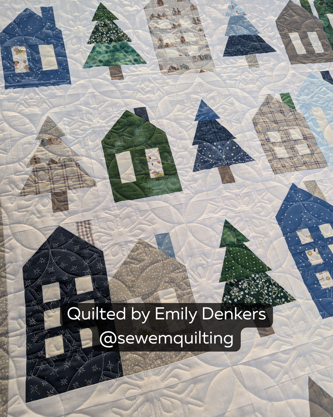 Finished winter village quilt featuring the Peeling Snowflakes Christmas digital pantograph with delicate snowflake motifs and flowing edge-to-edge quilting