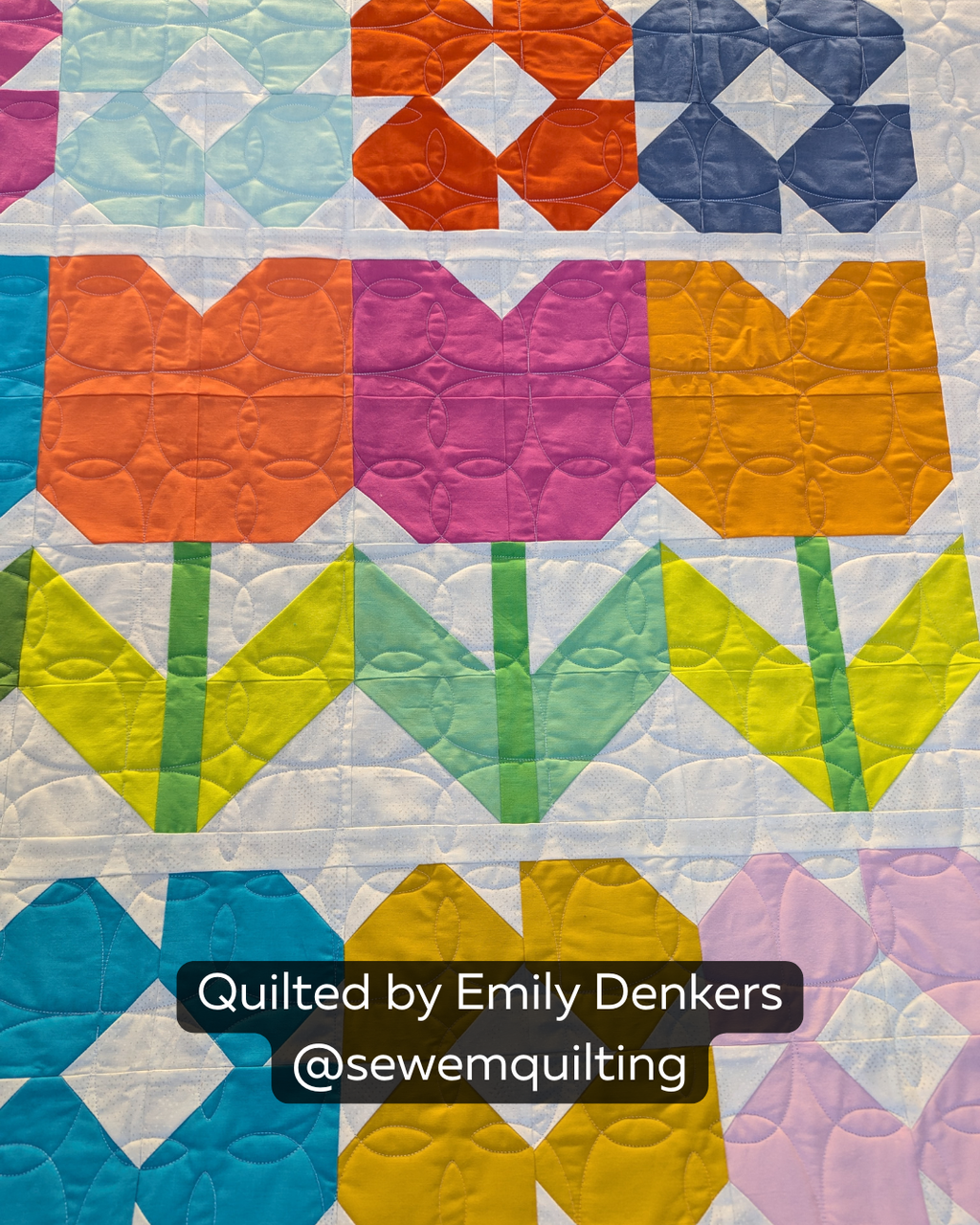 Finished colorful flower quilt featuring the Posy Peels floral digital quilting pantograph with elegant petal motifs and flowing edge-to-edge stitching