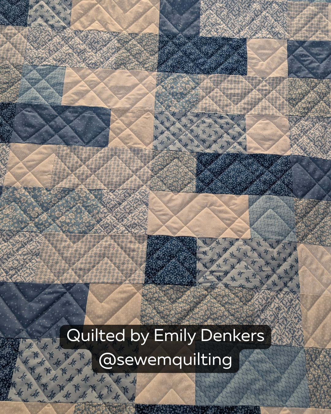 Finished blue and white patchwork quilt featuring the Practically Plaid quilting pantograph, with structured geometric grid lines stitched edge to edge.