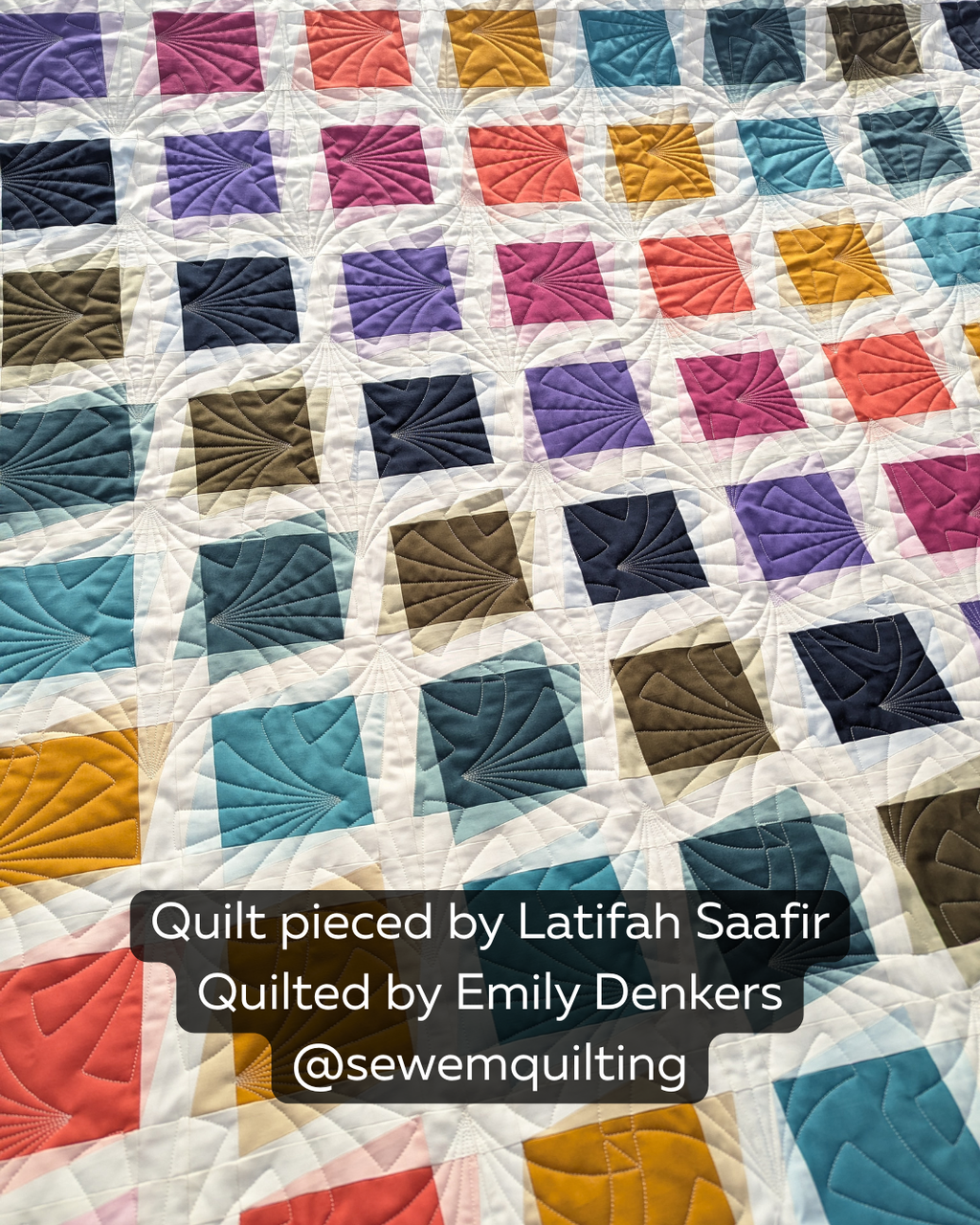Colorful geometric quilt stitched with the Radial Shells Segmented quilting pantograph
