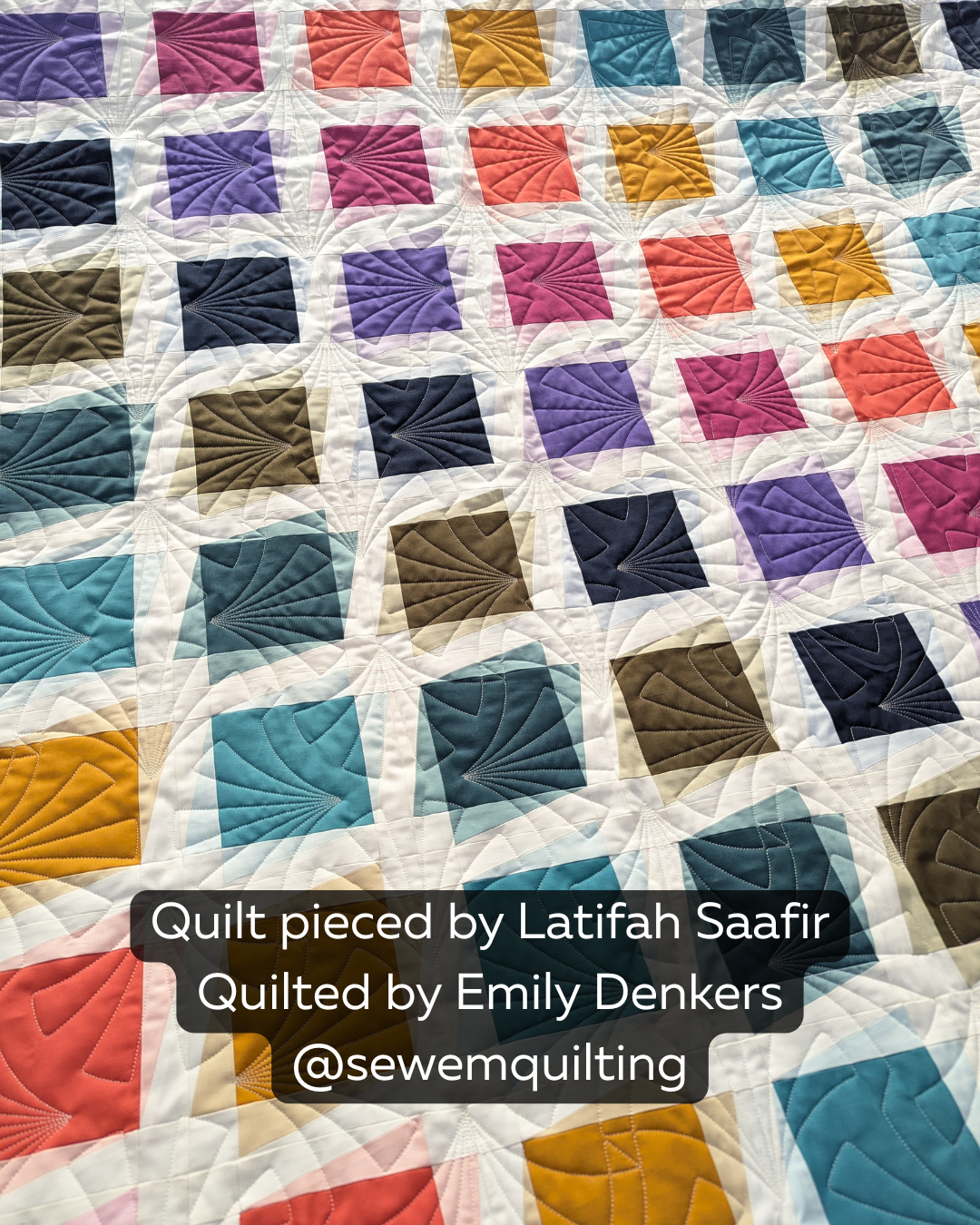 Colorful geometric quilt stitched with the Radial Shells Segmented quilting pantograph