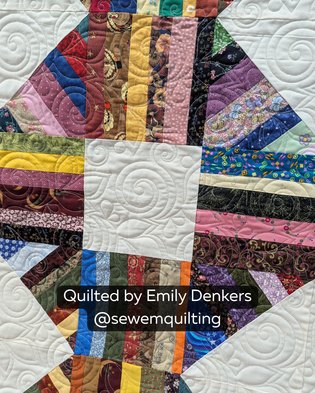 Finished colorful patchwork quilt featuring the Sprite Leaf Swirl digital quilting pantograph with graceful leaves, curls and flowing edge-to-edge texture