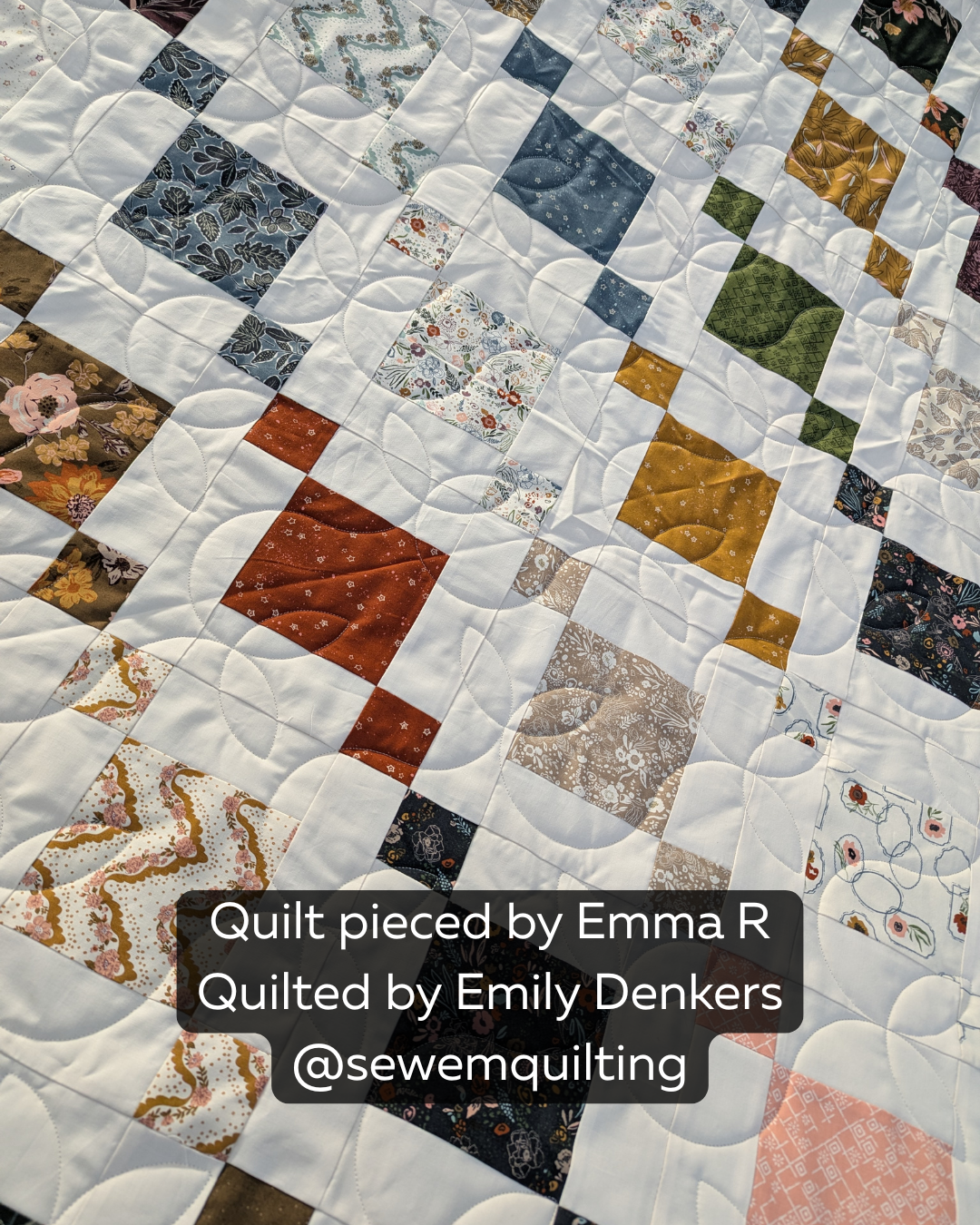 Sprouting digital pantograph with flowing leafy curves on a white and multicolored geometric quilt