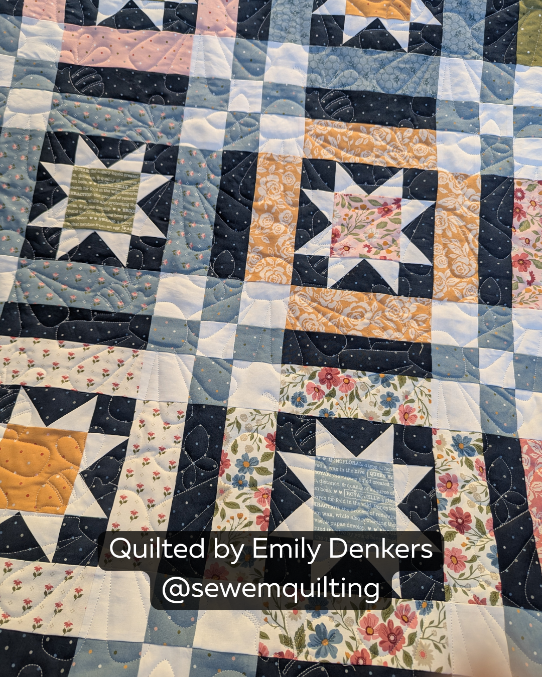 Finished blue, navy, white and golden patchwork quilt featuring the Summer Coneflowers Simple quilting pantograph, with cheerful floral petals stitched edge to edge.