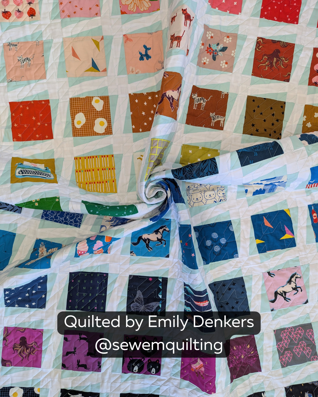"Finished quilt example using the Traditional Houndstooth pantograph, showing angular geometric stitching on a colorful novelty print patchwork quilt, quilted by Emily Denkers @sewemquilting"