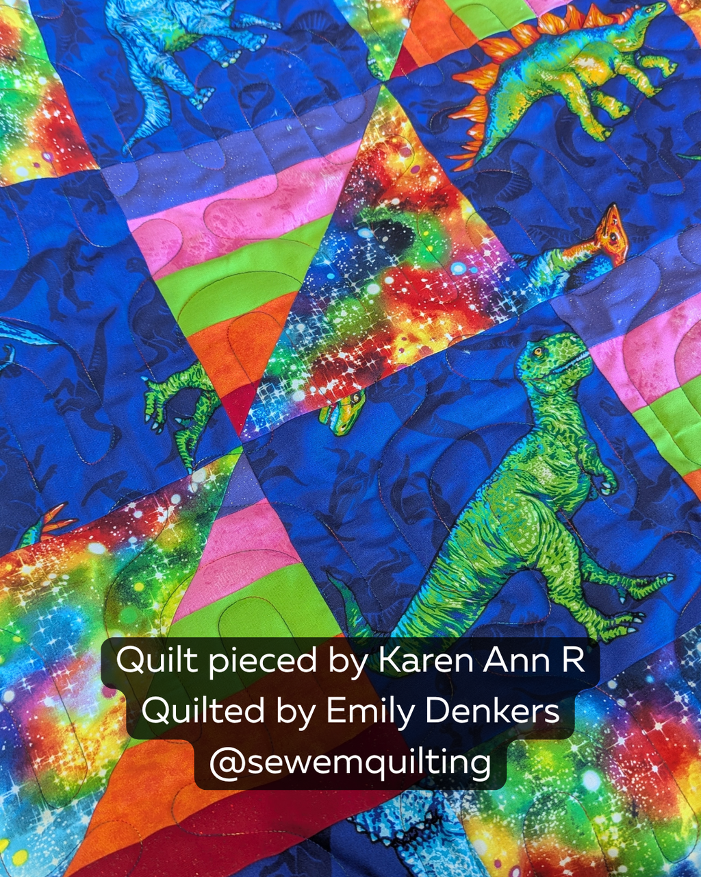 Vibrant dinosaur quilt bursting with rainbow colors, cosmic prints, and playful designs beautifully finished with the smooth curves of the Wiggle pantograph quilting pattern